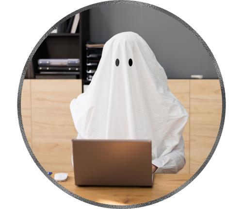 a representation of ghostwriting services by a man wearing ghost costume and writing on laptop